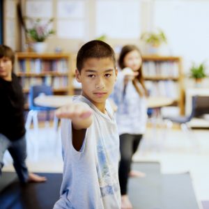 teens doing classroom yoga