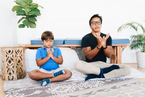 adult and child doing seated yoga