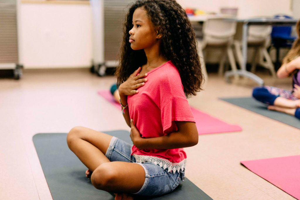 young lady doing breathing exercises