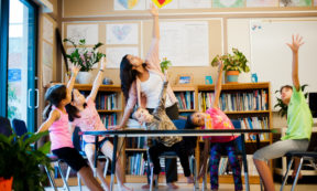 children doing yoga in classroom