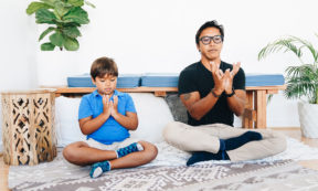 adult and child doing seated yoga