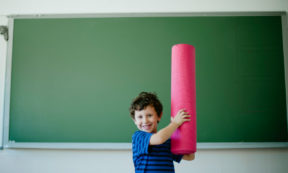 kid with yoga mat