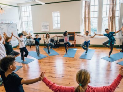 children doing classroom yoga
